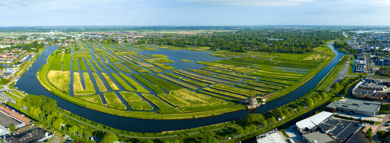 Aerial view of Oosterdel nature reserve featuring numerous small green islands and narrow waterways under a clear sky Broek op Langedijk Noord Holland Netherlands. Aerial view of Oosterdel nature reserve featuring numerous small green islands and narrow waterways under a clear sky Broek op Langedijk Noord Holland Netherlands.