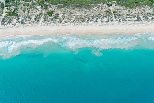 Aerial view of the pristine coastline with turquoise ocean waves crashing onto sandy beaches and dunes in Perth Western Australia Australia. Aerial view of the pristine coastline with turquoise ocean waves crashing onto sandy beaches and dunes in Perth Western Australia Australia.