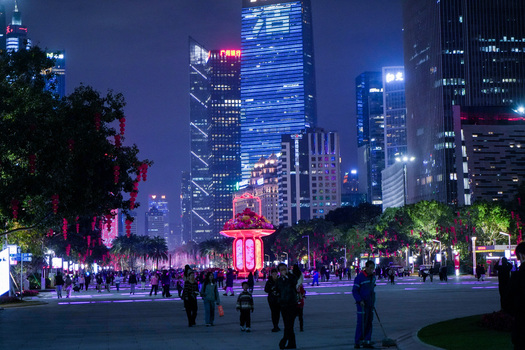 Guangzhou China 23 February 2024 View of the illuminated Huacheng Square at night with festive red lanterns modern skyscrapers and people walking along the plaza. Guangzhou China 23 February 2024 View of the illuminated Huacheng Square at night with festive red lanterns modern skyscrapers and people walking along the plaza.