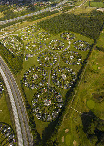 Aerial view of the unique circular garden communities of Brondby Haveby with houses arranged in perfect rings surrounded by green hedges and lush fields in Brondby Denmark. Aerial view of the unique circular garden communities of Brondby Haveby with houses arranged in perfect rings surrounded by green hedges and lush fields in Brondby Denmark.