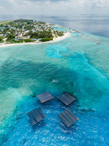 Aerial view of SolarSea floating solar power plant by Swimsol on turquoise coral reef waters near the tropical island coastline at Dharavandhoo Baa Atoll Maldives. Aerial view of SolarSea floating solar power plant by Swimsol on turquoise coral reef waters near the tropical island coastline at Dharavandhoo Baa Atoll Maldives.