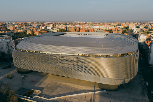 Aerial view of the Santiago Bernabeu stadium featuring its modern metallic facade surrounded by the urban landscape of Madrid Community of Madrid Spain. Aerial view of the Santiago Bernabeu stadium featuring its modern metallic facade surrounded by the urban landscape of Madrid Community of Madrid Spain.
