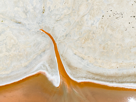 Aerial view of abstract patterns of a salt lake in the Mallee region with vibrant orange water channels and white salt crusts in Woorinen North Victoria Australia. Aerial view of abstract patterns of a salt lake in the Mallee region with vibrant orange water channels and white salt crusts in Woorinen North Victoria Australia.