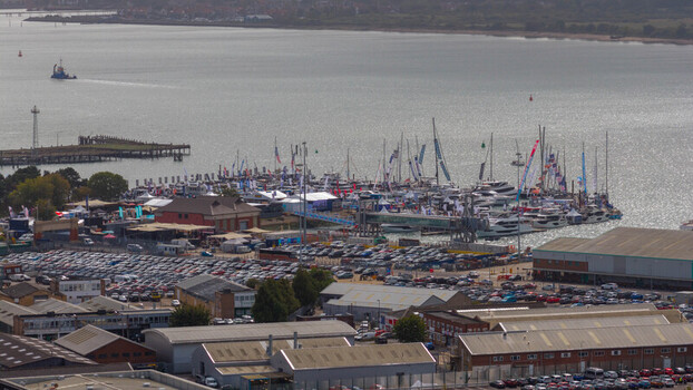 Aerial view of the Southampton International Boat Show with yachts and sailboats in the marina surrounded by industrial buildings and parking lots in Southampton England United Kingdom. Aerial view of the Southampton International Boat Show with yachts and sailboats in the marina surrounded by industrial buildings and parking lots in Southampton England United Kingdom.