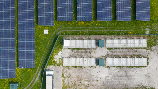 Aerial view of battery storage and mobile container charging at De Dijken Solar Park near Warmenhuizen supporting grid balance renewable energy and flexible power use. Aerial view of battery storage and mobile container charging at De Dijken Solar Park near Warmenhuizen supporting grid balance renewable energy and flexible power use.