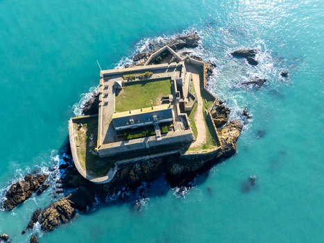 Aerial view of Fort National stands defiant against the turquoise sea its weathered stone walls a testament to history Fort National Saint Malo Brittany France. Aerial view of Fort National stands defiant against the turquoise sea its weathered stone walls a testament to history Fort National Saint Malo Brittany France.