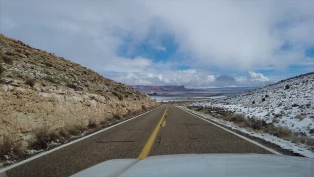 View of a desolate road through snowy desert mountains United States. View of a desolate road through snowy desert mountains United States.