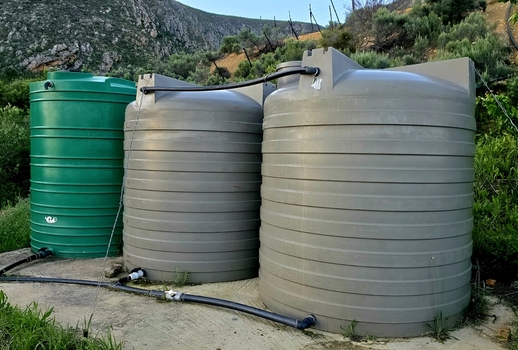 View of large plastic water storage tanks connected by pipes on a farm in Hoeko Western Cape South Africa.