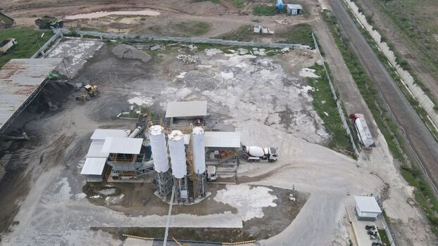Aerial view of the Dhoho International Airport construction site featuring concrete silos heavy machinery and industrial infrastructure in Kecamatan Grogol Jawa Timur Indonesia. Aerial view of the Dhoho International Airport construction site featuring concrete silos heavy machinery and industrial infrastructure in Kecamatan Grogol Jawa Timur Indonesia.