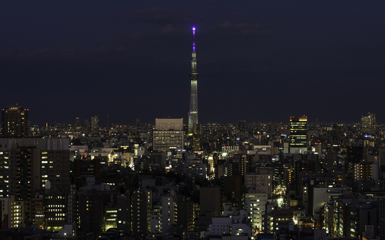 Aerial view of Tokyo Skytree pierces the twilight its illuminated spire a beacon amid the sprawling cityscape s warm glow Bunkyo City Tokyo Japan. Aerial view of Tokyo Skytree pierces the twilight its illuminated spire a beacon amid the sprawling cityscape s warm glow Bunkyo City Tokyo Japan.