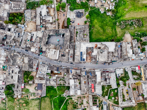 Aerial view of the urban sprawl where buildings and roads meet patches of green a contrast of textures and tones Chakswari Azad Kashmir Pakistan. Aerial view of the urban sprawl where buildings and roads meet patches of green a contrast of textures and tones Chakswari Azad Kashmir Pakistan.