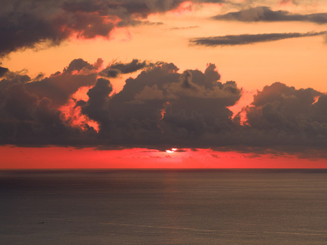 Aerial view of the sunset over the Indian Ocean near Mauritius Island with dramatic red clouds and calm water Moka District Mauritius. Aerial view of the sunset over the Indian Ocean near Mauritius Island with dramatic red clouds and calm water Moka District Mauritius.
