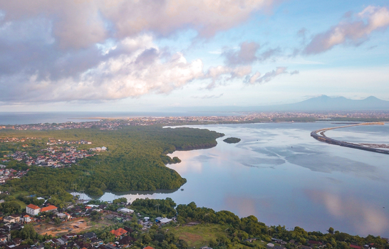 Aerial view of a scenic coastline on a cloudy day in Uluwatu south of Bali island Indonesia.