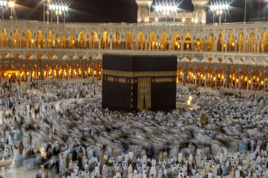 Aerial view of the Kaaba at Masjid al Haram surrounded by a large crowd of pilgrims performing circumambulation in Makkah Makkah Province Saudi Arabia. Aerial view of the Kaaba at Masjid al Haram surrounded by a large crowd of pilgrims performing circumambulation in Makkah Makkah Province Saudi Arabia.