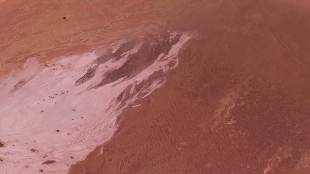 Aerial view of the vibrant pink salt lakes and industrial patterns at Useless Loop showing contrasting textures of sand and salt deposits in Kalbarri Western Australia Australia. Aerial view of the vibrant pink salt lakes and industrial patterns at Useless Loop showing contrasting textures of sand and salt deposits in Kalbarri Western Australia Australia.