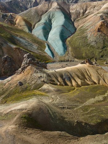 Aerial view of Landmannalaugar featuring vibrant rhyolite mountains with colorful slopes mossy green patches and rugged volcanic terrain in Hella Rangarthing ytra Iceland. Aerial view of Landmannalaugar featuring vibrant rhyolite mountains with colorful slopes mossy green patches and rugged volcanic terrain in Hella Rangarthing ytra Iceland.