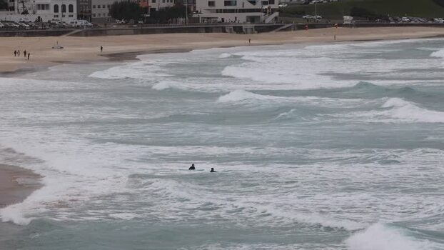 View of surfers in the ocean at Bondi Beach Australia.