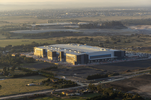 Craigieburn Australia 30 April 2026 Aerial view of the large industrial warehouse at 65 Amaroo Rd surrounded by open fields and suburban landscapes under a hazy morning sky. Craigieburn Australia 30 April 2026 Aerial view of the large industrial warehouse at 65 Amaroo Rd surrounded by open fields and suburban landscapes under a hazy morning sky.