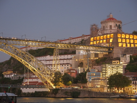 View of the iconic Dom Luis I Bridge illuminated at dusk spanning the Douro River with the historic Monastery of Serra do Pilar in the background Porto Porto District Portugal. View of the iconic Dom Luis I Bridge illuminated at dusk spanning the Douro River with the historic Monastery of Serra do Pilar in the background Porto Porto District Portugal.