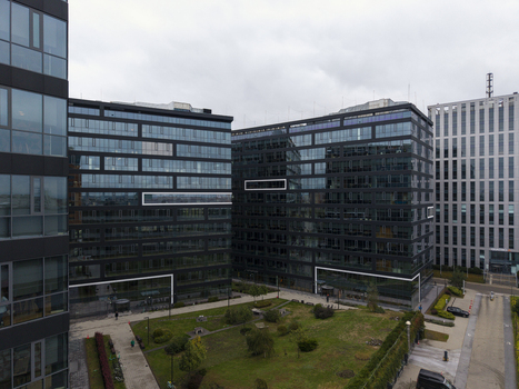 Aerial view of modern glass office buildings in a business park with landscaped green areas in Krakow Lesser Poland Voivode Poland.