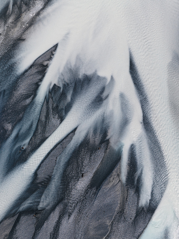 Aerial view of braided river patterns carve through the landscape a dance of light and shadow on the glacial outwash plains Lake Tekapo New Zealand. Aerial view of braided river patterns carve through the landscape a dance of light and shadow on the glacial outwash plains Lake Tekapo New Zealand.
