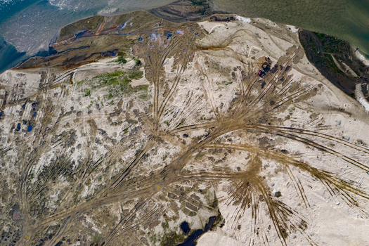 Aerial view of extensive vehicle tracks crisscrossing the sandy riverbed and terrain in Panchagarh Rangpur Division Bangladesh. Aerial view of extensive vehicle tracks crisscrossing the sandy riverbed and terrain in Panchagarh Rangpur Division Bangladesh.