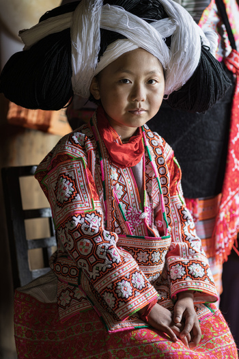 Gaoxing China 29 April 2026 View of a young girl wearing the traditional Long Horn Miao costume with a large horn shaped headpiece and intricate embroidery. Gaoxing China 29 April 2026 View of a young girl wearing the traditional Long Horn Miao costume with a large horn shaped headpiece and intricate embroidery.