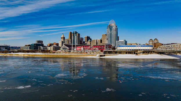 Aerial view of the Cincinnati skyline and Great American Ball Park along the icy Ohio River under a clear blue sky Cincinnati Ohio United States. Aerial view of the Cincinnati skyline and Great American Ball Park along the icy Ohio River under a clear blue sky Cincinnati Ohio United States.