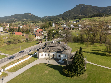 Aerial view of the historic Kastiel Kubinyi manor house and the Velky Choc mountain peak on the horizon in Vysny Kubin Zilinsky kraj Slovakia.