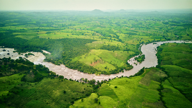 Aerial view of the Gurara Waterfalls flowing through a lush green landscape with rolling hills and dense vegetation in Lambata Niger Nigeria. Aerial view of the Gurara Waterfalls flowing through a lush green landscape with rolling hills and dense vegetation in Lambata Niger Nigeria.