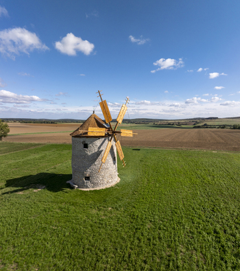 Aerial view of the historic Regi Szelmalom windmill standing amidst green fields and agricultural land Tes Hungary. Aerial view of the historic Regi Szelmalom windmill standing amidst green fields and agricultural land Tes Hungary.