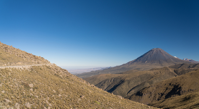 View of the Misti volcano rising above the arid rocky landscape of the Andes mountains in Arequipa Arequipa Peru. View of the Misti volcano rising above the arid rocky landscape of the Andes mountains in Arequipa Arequipa Peru.
