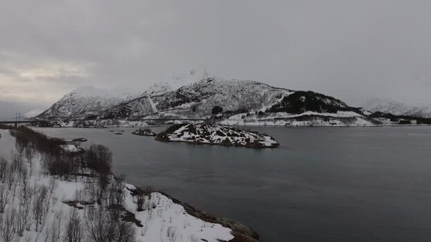 Aerial view of Lofoten mountains and snowy coastline Norway.