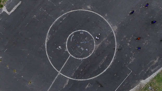 Aerial view of the National Stadium Surulere Lagos with people playing on an asphalt court with white circular markings in Lagos Lagos Nigeria. Aerial view of the National Stadium Surulere Lagos with people playing on an asphalt court with white circular markings in Lagos Lagos Nigeria.
