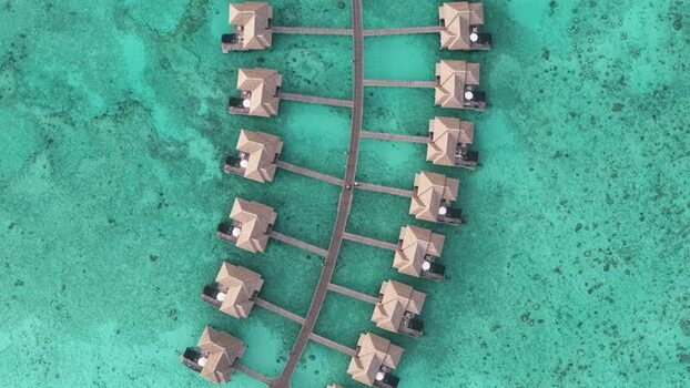 Aerial view of overwater bungalows and turquoise water Maldives. Aerial view of overwater bungalows and turquoise water Maldives.