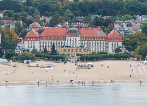 Aerial view of the historic Grand Hotel in Sopot with its distinctive red roof situated along the sandy beach and the Baltic Sea coast in Sopot Pomeranian Voivodeship Poland. Aerial view of the historic Grand Hotel in Sopot with its distinctive red roof situated along the sandy beach and the Baltic Sea coast in Sopot Pomeranian Voivodeship Poland.