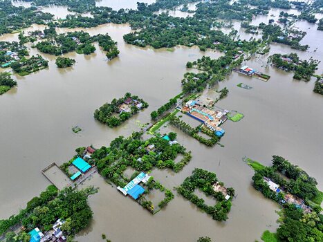 Banshkhali Upazila Chittagong Bangladesh 10 July 2026 Aerial view of flooded rural landscape with submerged houses lush green trees and brown floodwaters covering fields. Banshkhali Upazila Chittagong Bangladesh 10 July 2026 Aerial view of flooded rural landscape with submerged houses lush green trees and brown floodwaters covering fields.