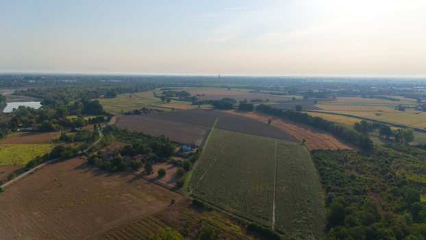 Aerial view of the Po River with low water levels due to drought exposing sediments beaches and riverbed in the rural landscape of Castelvetro Piacentino Emilia Romagna Italy. Aerial view of the Po River with low water levels due to drought exposing sediments beaches and riverbed in the rural landscape of Castelvetro Piacentino Emilia Romagna Italy.