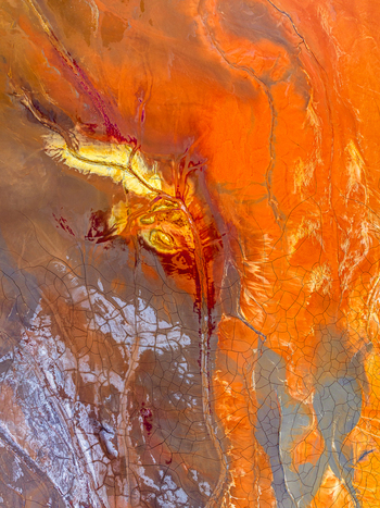 Aerial view of vibrant mineral deposits and cracked earth patterns at a mining site in Andalusia Spain. Aerial view of vibrant mineral deposits and cracked earth patterns at a mining site in Andalusia Spain.