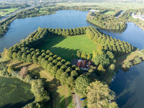 Aerial view of the historic Pettelaarse Schans a star shaped fortification surrounded by a moat and lush green trees in s Hertogenbosch Noord Brabant Netherlands.