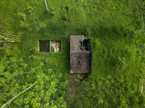 Aerial view of Houses Damaged by Mount Merapi Eruption with collapsed roofs surrounded by dense green forest Cangkringan Special Region of Yogyakarta Indonesia. Aerial view of Houses Damaged by Mount Merapi Eruption with collapsed roofs surrounded by dense green forest Cangkringan Special Region of Yogyakarta Indonesia.