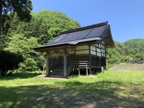 Japan 06 July 2026 View of a traditional wooden shrine with a dark tiled roof nestled in a lush green landscape with forested mountains under a clear blue sky. Japan 06 July 2026 View of a traditional wooden shrine with a dark tiled roof nestled in a lush green landscape with forested mountains under a clear blue sky.