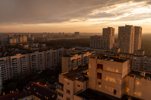 Aerial view of residential buildings bathed in the warm glow of the setting sun painting the skyline with hues of gold and amber Kyiv Kyiv city Ukraine. Aerial view of residential buildings bathed in the warm glow of the setting sun painting the skyline with hues of gold and amber Kyiv Kyiv city Ukraine.