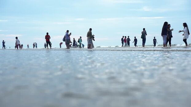 View of people on Cox s Bazar beach in shallow water Bangladesh. View of people on Cox s Bazar beach in shallow water Bangladesh.