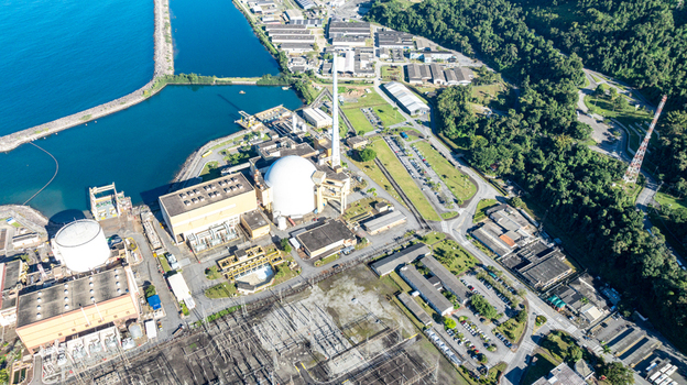 Aerial view of the Nuclear Power Plant Angra 2 featuring its iconic white dome industrial buildings and cooling infrastructure in Angra dos Reis Rio de Janeiro Brazil.