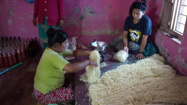 View of women processing noodles in a local workshop Nepal. View of women processing noodles in a local workshop Nepal.