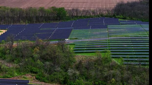Aerial view of solar farm panels on a green hillside in Lebanon United States. Aerial view of solar farm panels on a green hillside in Lebanon United States.