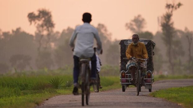 View of people on a rural road with a rickshaw Bangladesh.