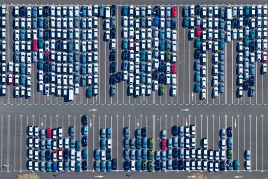 Aerial view of a vast car park filled with rows of vehicles in orderly lines gleaming under the sun a testament to organized urban space Sausheim Grand Est France.
