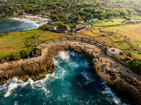 Aerial view of the dramatic Devil s Tears coastal landmark with crashing waves rugged cliffs and surrounding lush green landscape in Kecamatan Nusa Penida Bali Indonesia. Aerial view of the dramatic Devil s Tears coastal landmark with crashing waves rugged cliffs and surrounding lush green landscape in Kecamatan Nusa Penida Bali Indonesia.